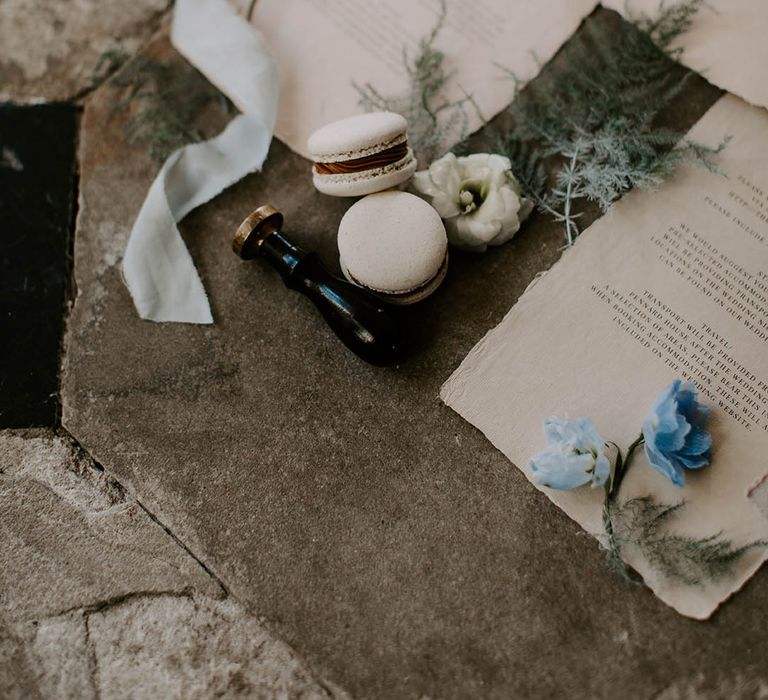 wax seal stamp and macaroon favours on stationery flay lay 