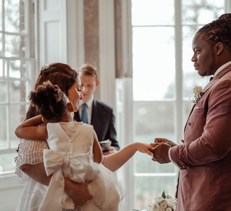 Bride & groom hold hands on their wedding day