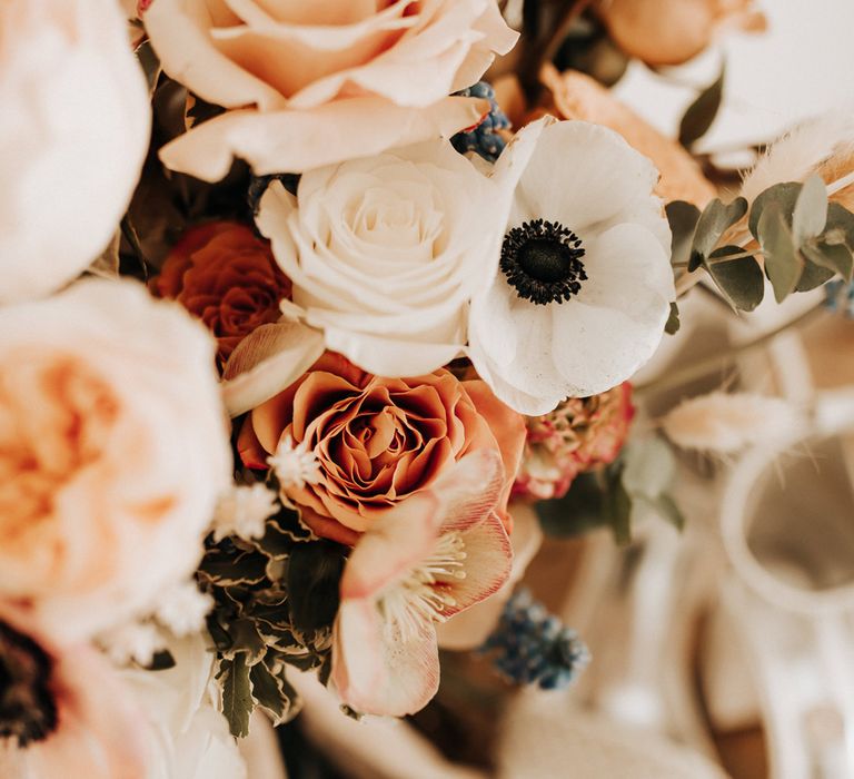 Mixed pastel wedding bouquet with roses and anemones 