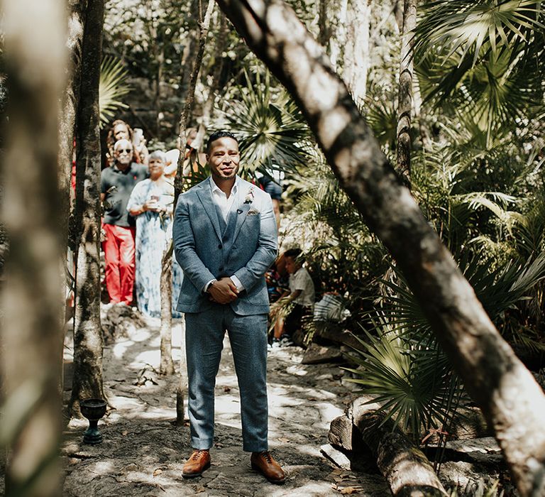 Groom waits for bride at Mayan wedding ceremony in Tulum 