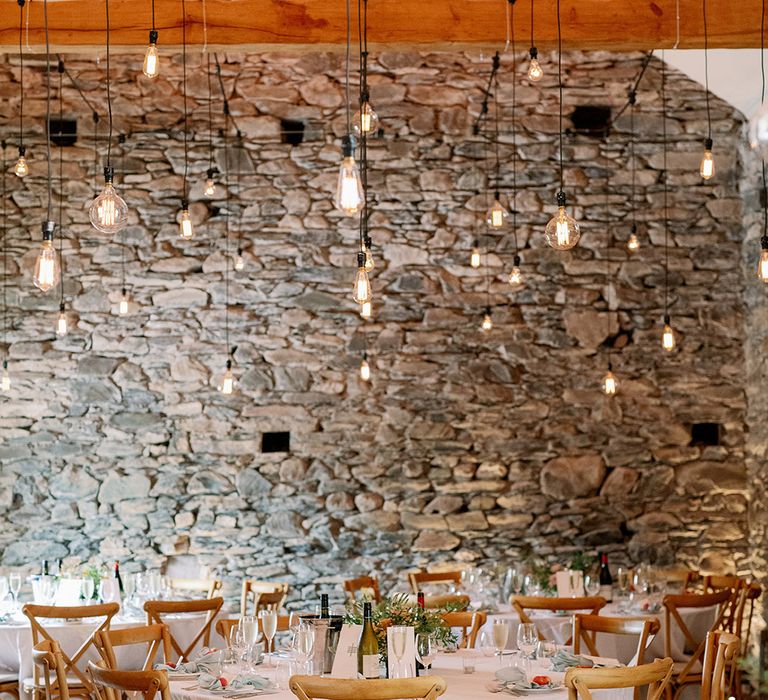 Simple and elegant wedding reception with hanging exposed lightbulbs for decoration 