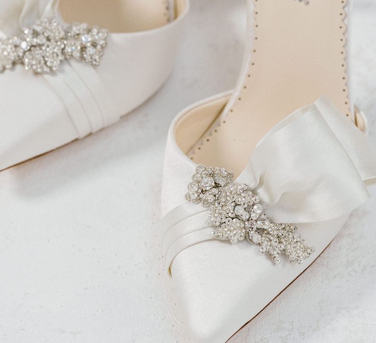 White satin pointed wedding stilettos with ruffle detail and crystal embellishment 