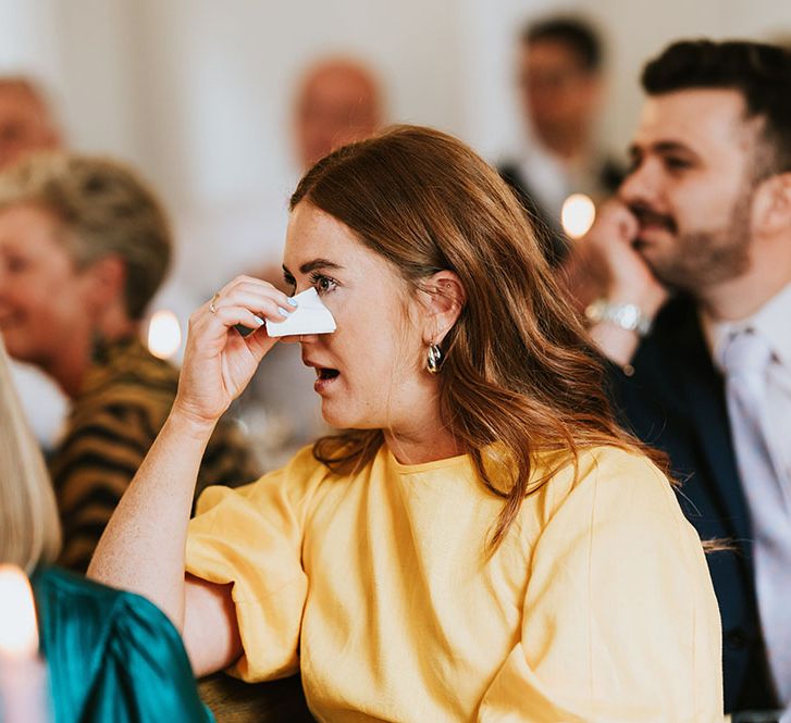 Wedding guest wearing yellow becomes emotional during reception speeches 