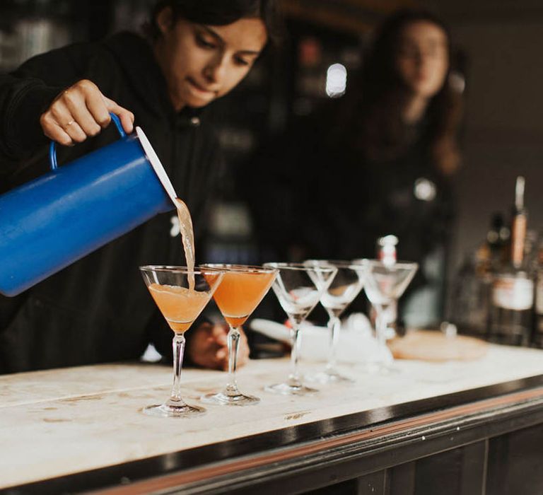 Bar staff pour out the wedding cocktail 