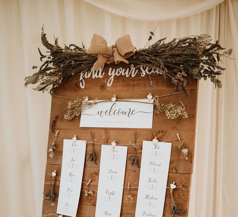 DIY wooden seating chart complete with mini heart shaped pegs and white stationery 