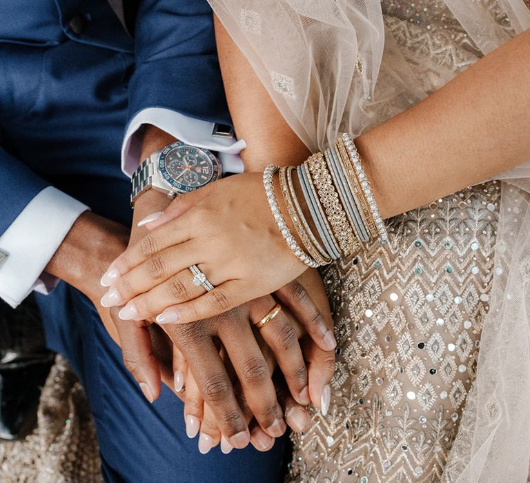 Bride wears embellished bangles and diamond engagement ring 