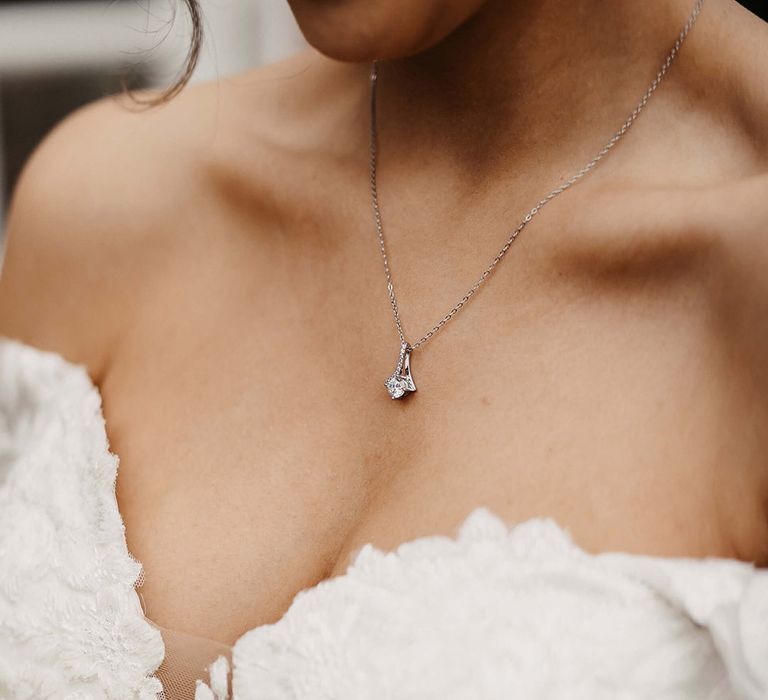 Bride wearing a silver necklace with a diamond pendant bridal jewellery