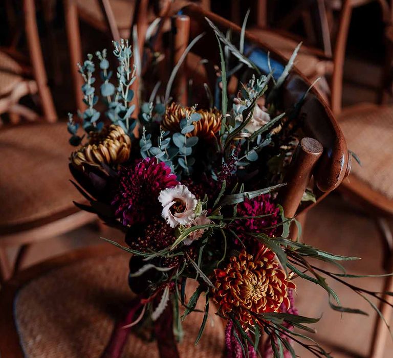 Autumnal dried flower bouquet with peonies, foliage and roses