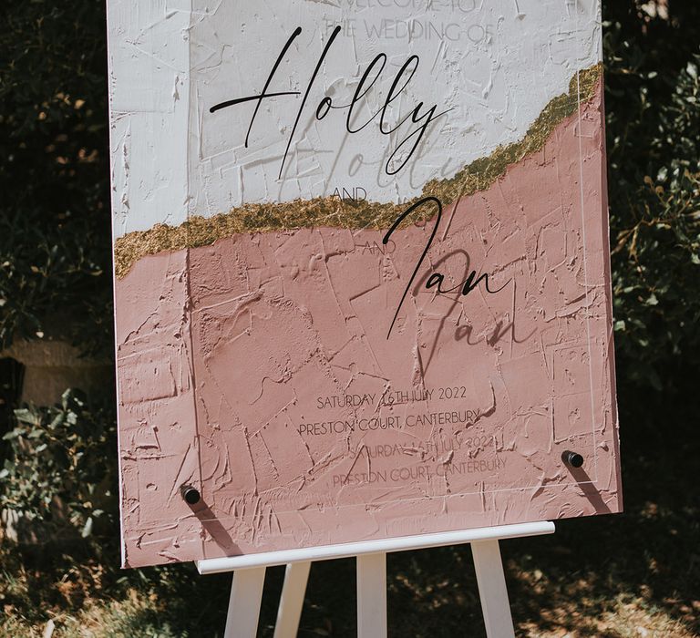 Pink, white, and gold wedding welcome sign DIY'd by the bride with acrylic clear signage 