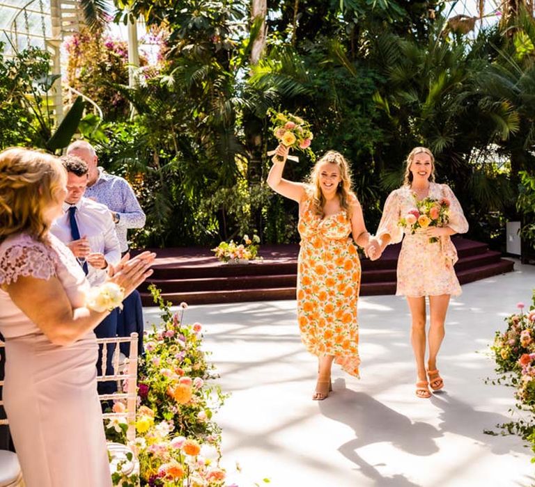 Bridesmaids in mismatched floral bridesmaid dresses for the glasshouse wedding 