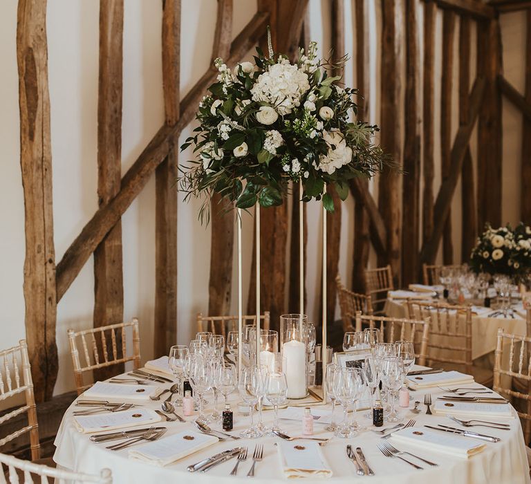 Tall white flower wedding table centrepiece at Villiers Barn wedding venue with minimalistic styling 