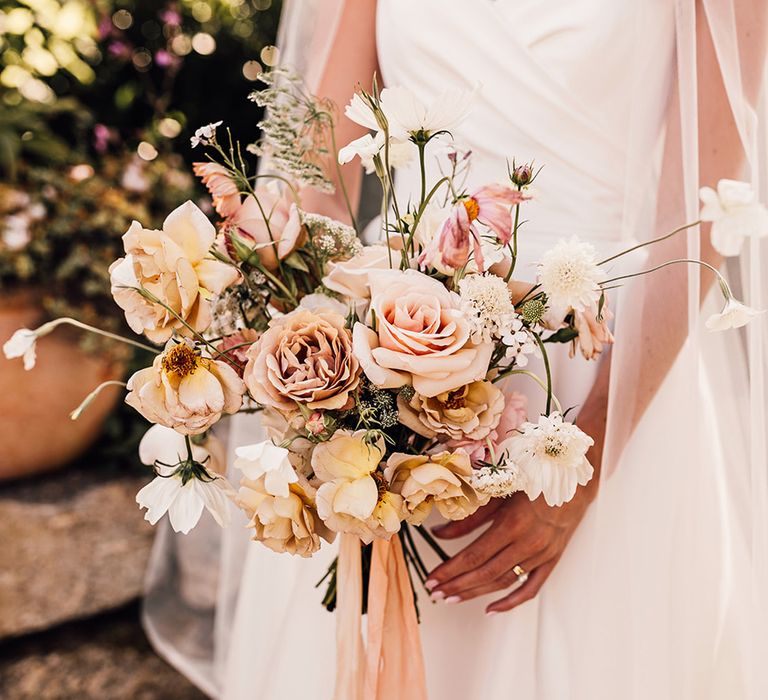 cafe au lait and pink rose wedding bouquet tied with ribbon 