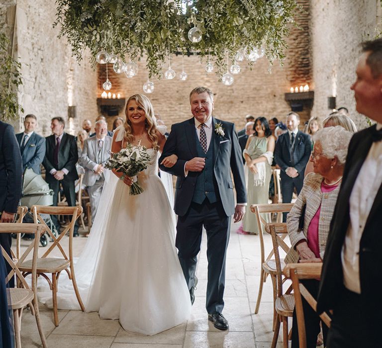 Father of the bride in three piece navy suit walking the bride down the aisle in Eve Lendel wedding dress 