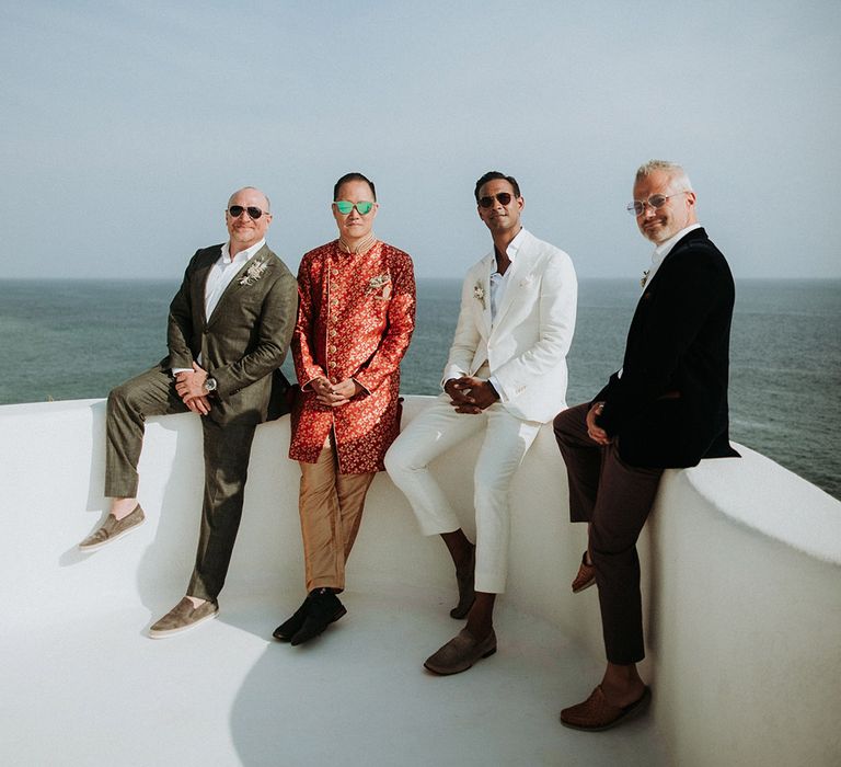 Groom in cream wedding suit with groomsmen at Tigre Del Mar wedding