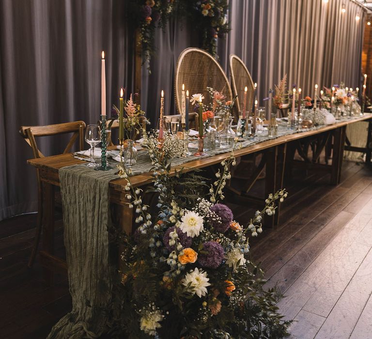 Boho peacock chairs at the top table for botanical wedding with pastel wedding decorations 