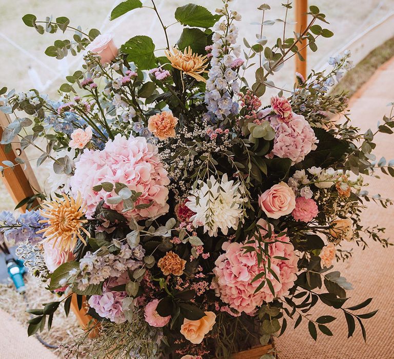 Pastel coloured pink and white wedding flower arrangements 