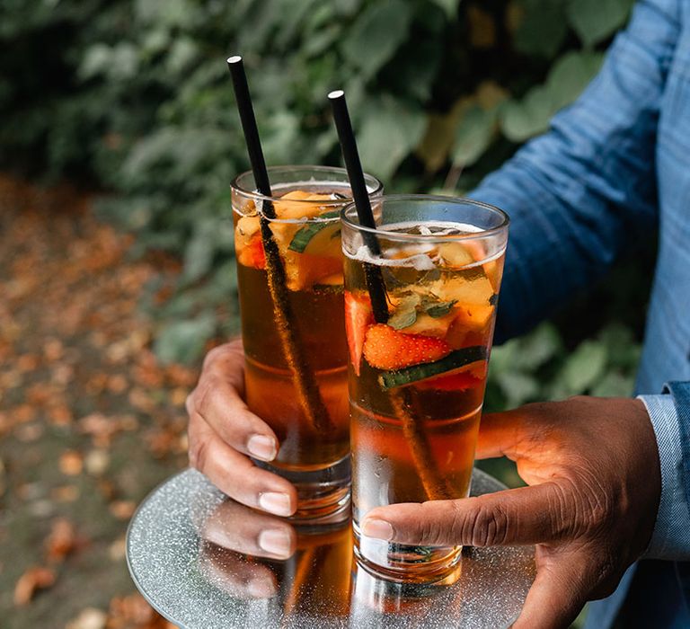 Colourful orange wedding cocktail drinks served at Surrey wedding 