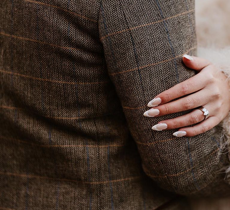 Bride wearing French tip wedding nails with pearls for boho wedding 