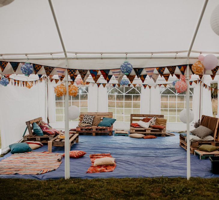 Marquee chill out area with cushions and bunting