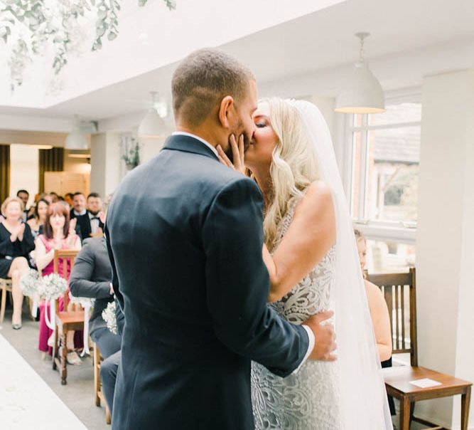 Bride and groom kissing during the wedding ceremony 