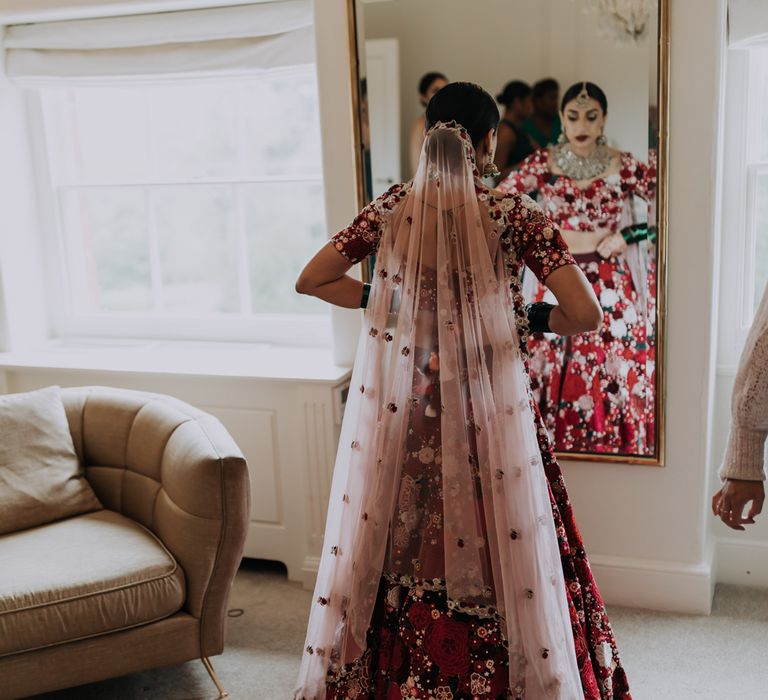 Indian bride in red dress for a multicultural wedding at Winstanley House Leicester