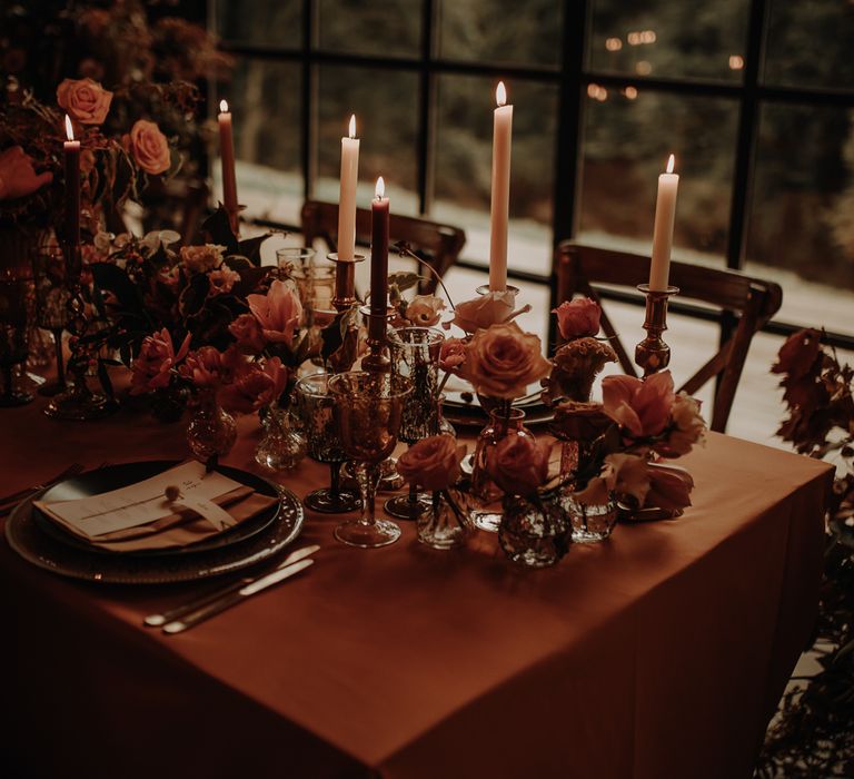 Wedding table decor with candles and flower stems 