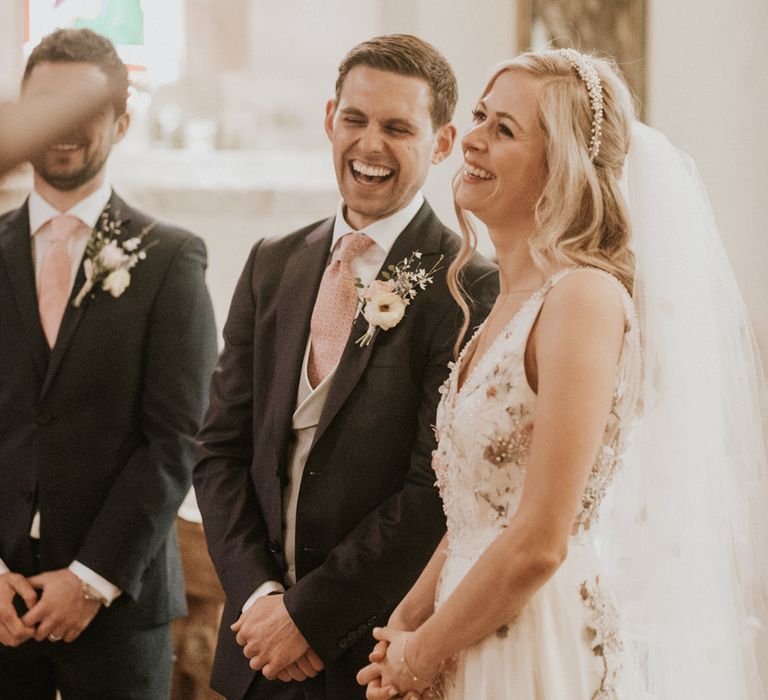 Bride and groom smiling during the church wedding ceremony 