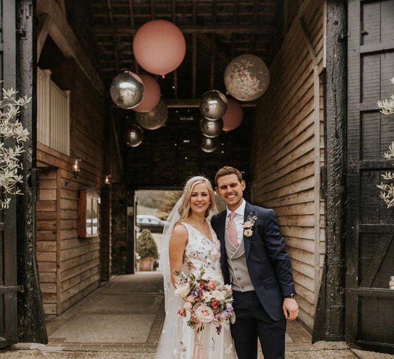 Bride and groom portrait by Nataly J Photography outside Upwaltham Barns