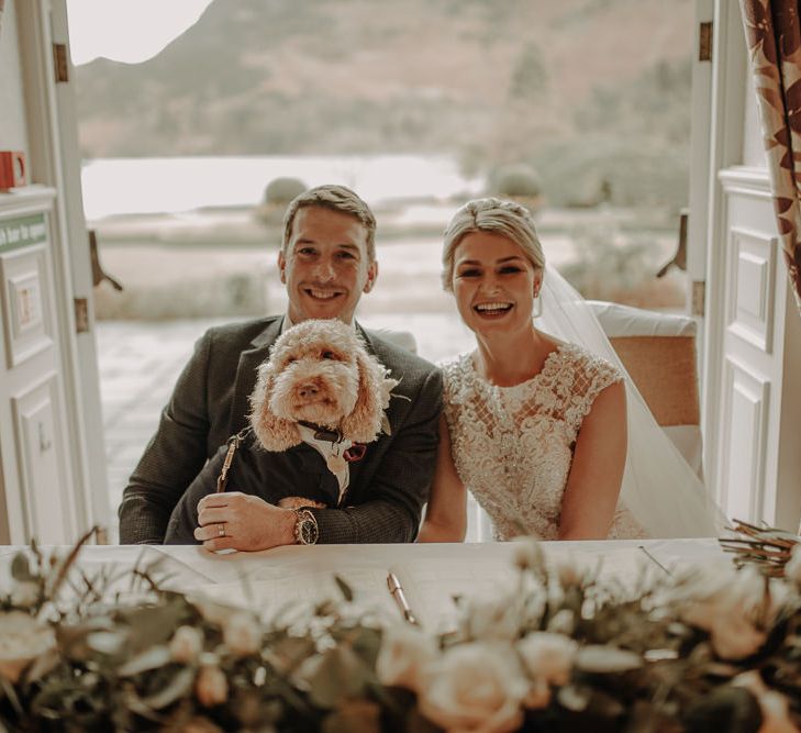 Bride and groom with guest of honor, Henry the dog outlooking beautiful Lake District views 