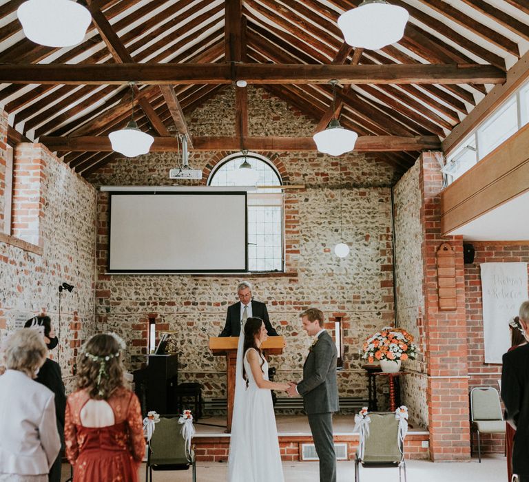 Bride and groom exchanging vows at August 2020 wedding 