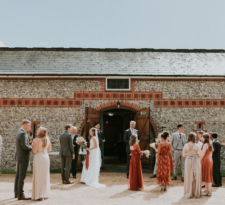 Wedding guests standing outside Horsley Evangelical Church in Surrey 