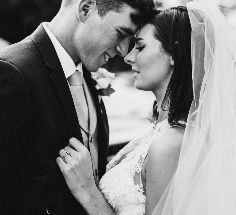 Bride & groom embrace in black and white image