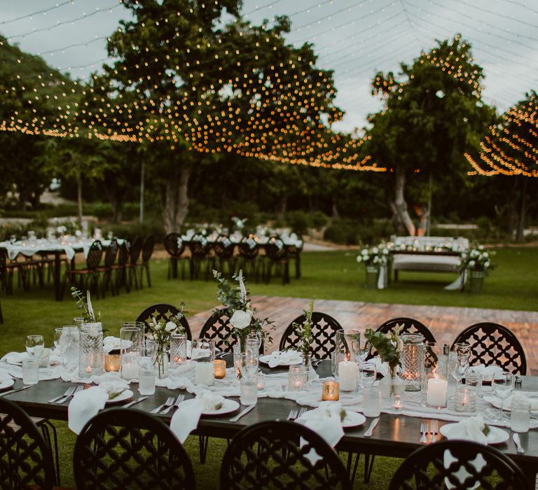 Candlelit tables outline the outdoor dance floor