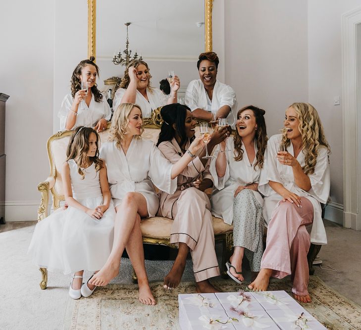 Bridal party drinking champagne on the wedding morning 