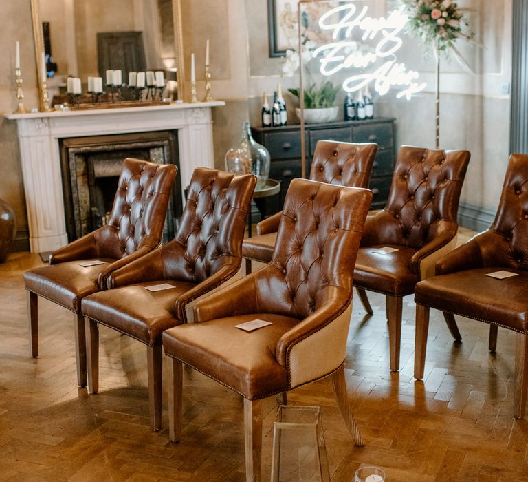 Rustic brown seating and happily ever after sign for relaxed intimate wedding ceremony 