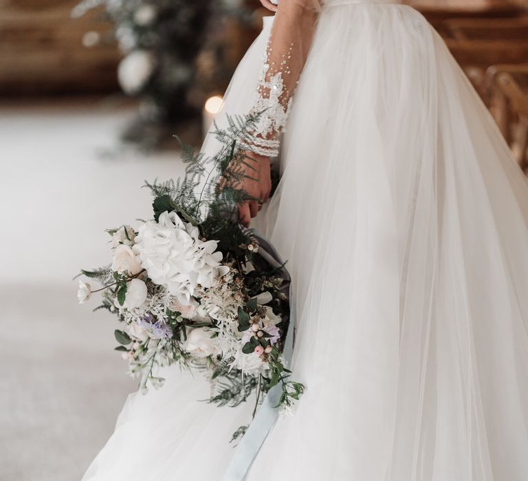 The bride wore a lace long sleeve gown with a detachable skirt