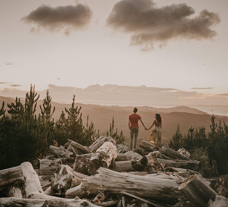 The bride and groom look at the stunning views over New Zealand