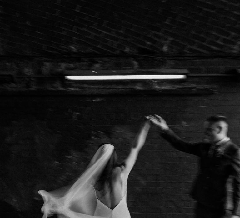 Bride and groom dancing in London underpass 