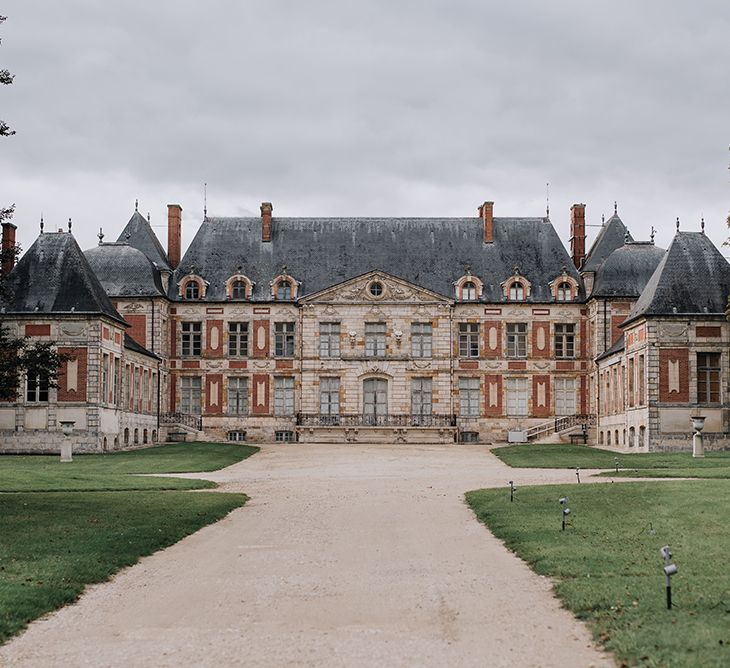 Long driveway leading up to a French chateau