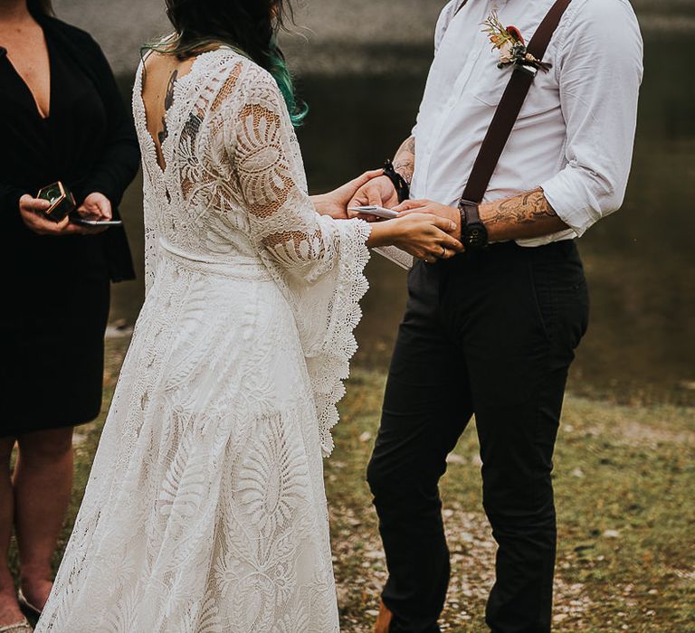 Bride & groom hold hands during wedding ceremony