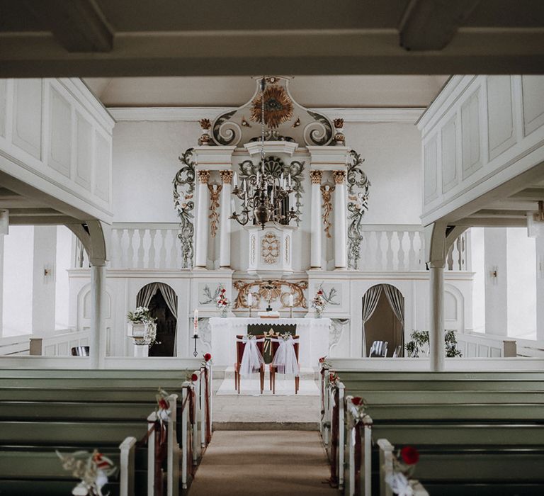 White and green interior of German church for wedding ceremony