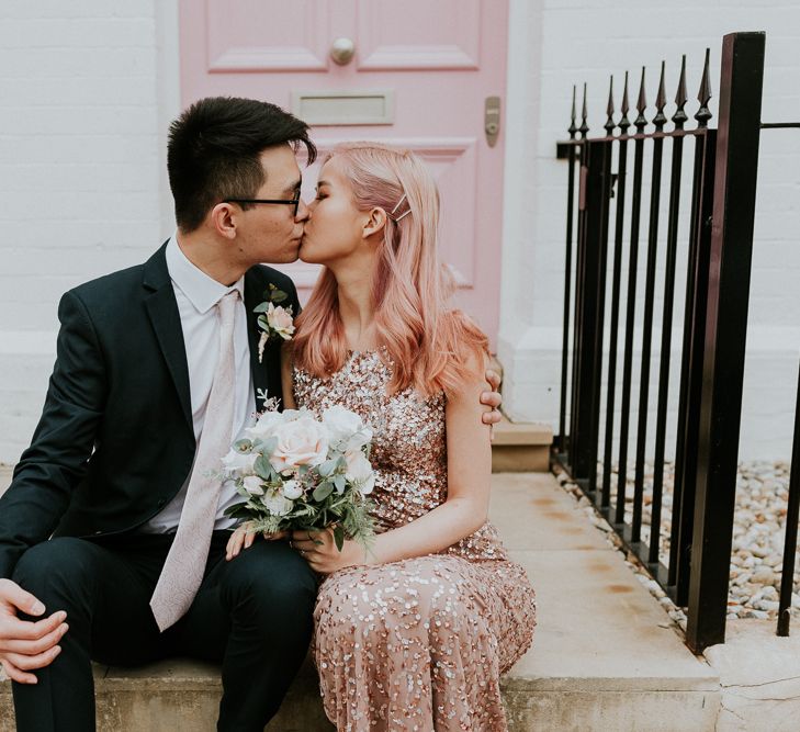 Bride and groom kissing on some steps in Chelsea 