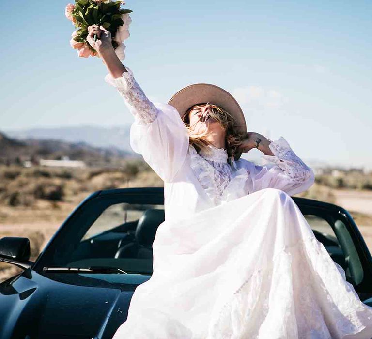 Bride sits on car for Las Vegas wedding shoot