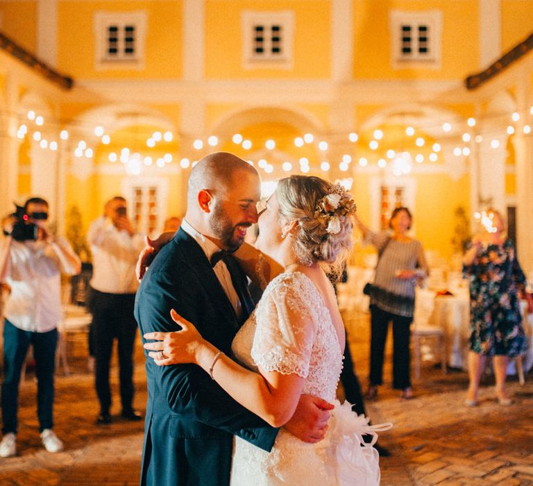 The bride and groom sharing their first dance in the courtyard of Tenuta Pegazzera