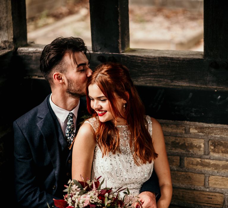 Bride & groom sit together on wedding day 