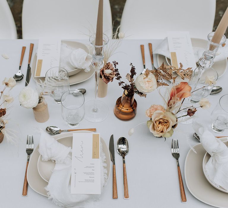 All white wedding tablescape inspiration with dried flowers, white tableware and wooden cutlery