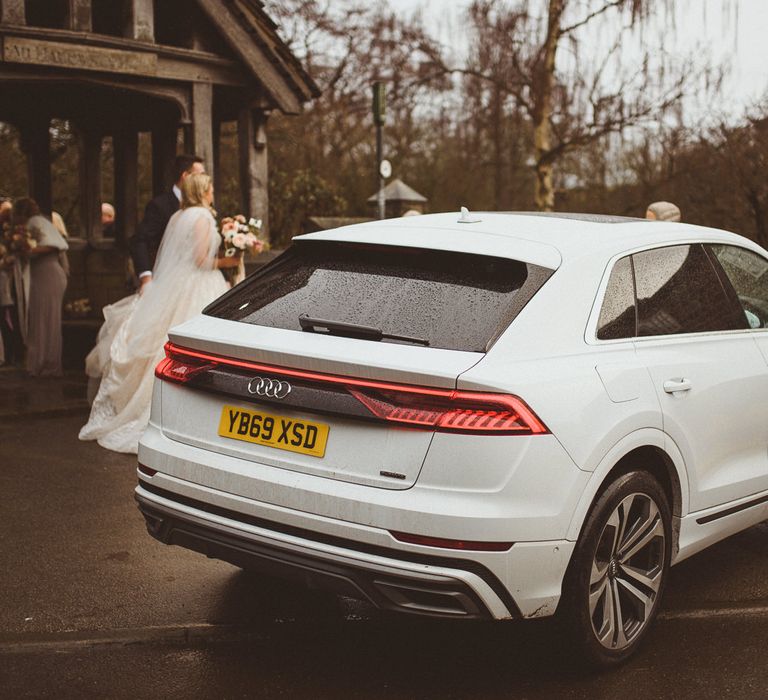 White Audi wedding cake outside the church