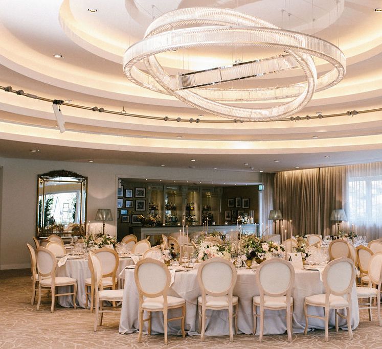 Elegant wedding at Grantley Hall wedding venue with Ivory Louis chairs, soft grey gently puddled linen and Erik & Ester tapered candles