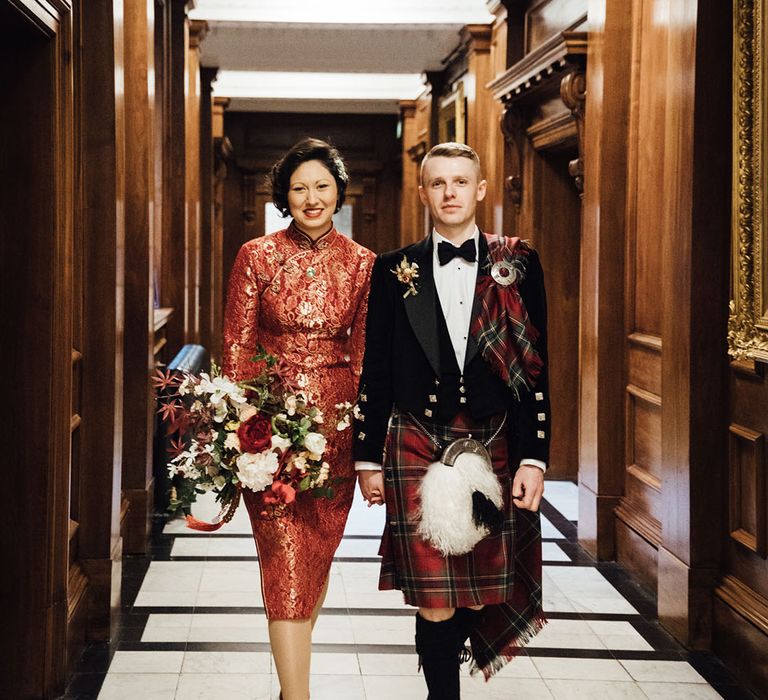 Bride in traditional cheongsam dress with groom at Old Marylebone Town Hall wedding