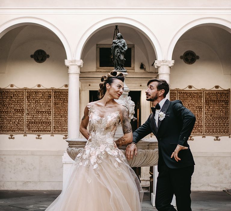 Bride & groom look lovingly at one another as they pose after their wedding ceremony